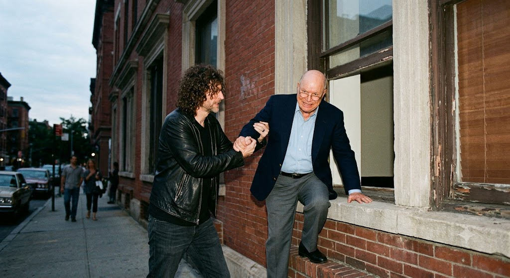 howard stern helping don rickles climb into a buil