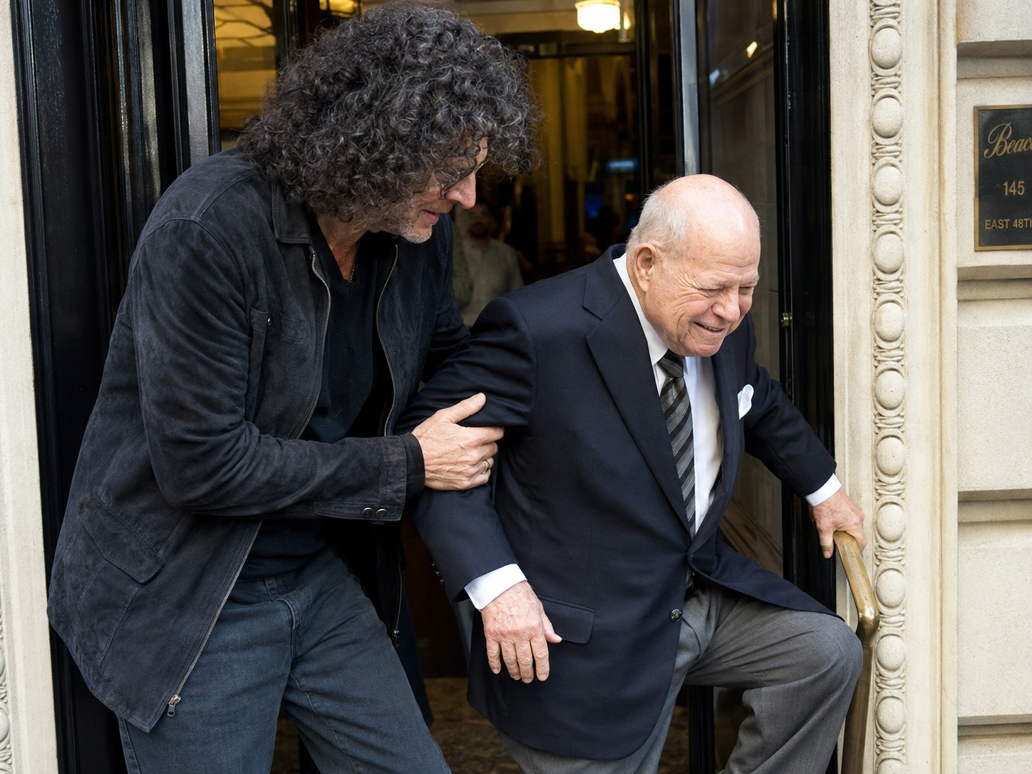 howard stern helping don rickles climb into a buil